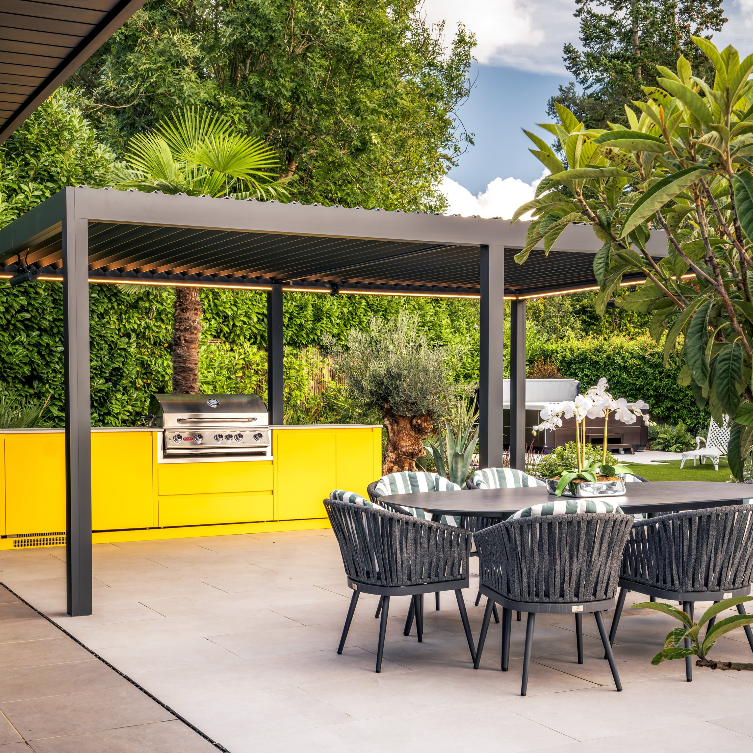 Yellow Oliveti outdoor kitchen under pergola