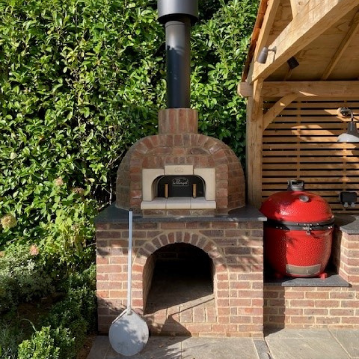 Le Panyol wood-fired pizza oven in outdoor kitchen design